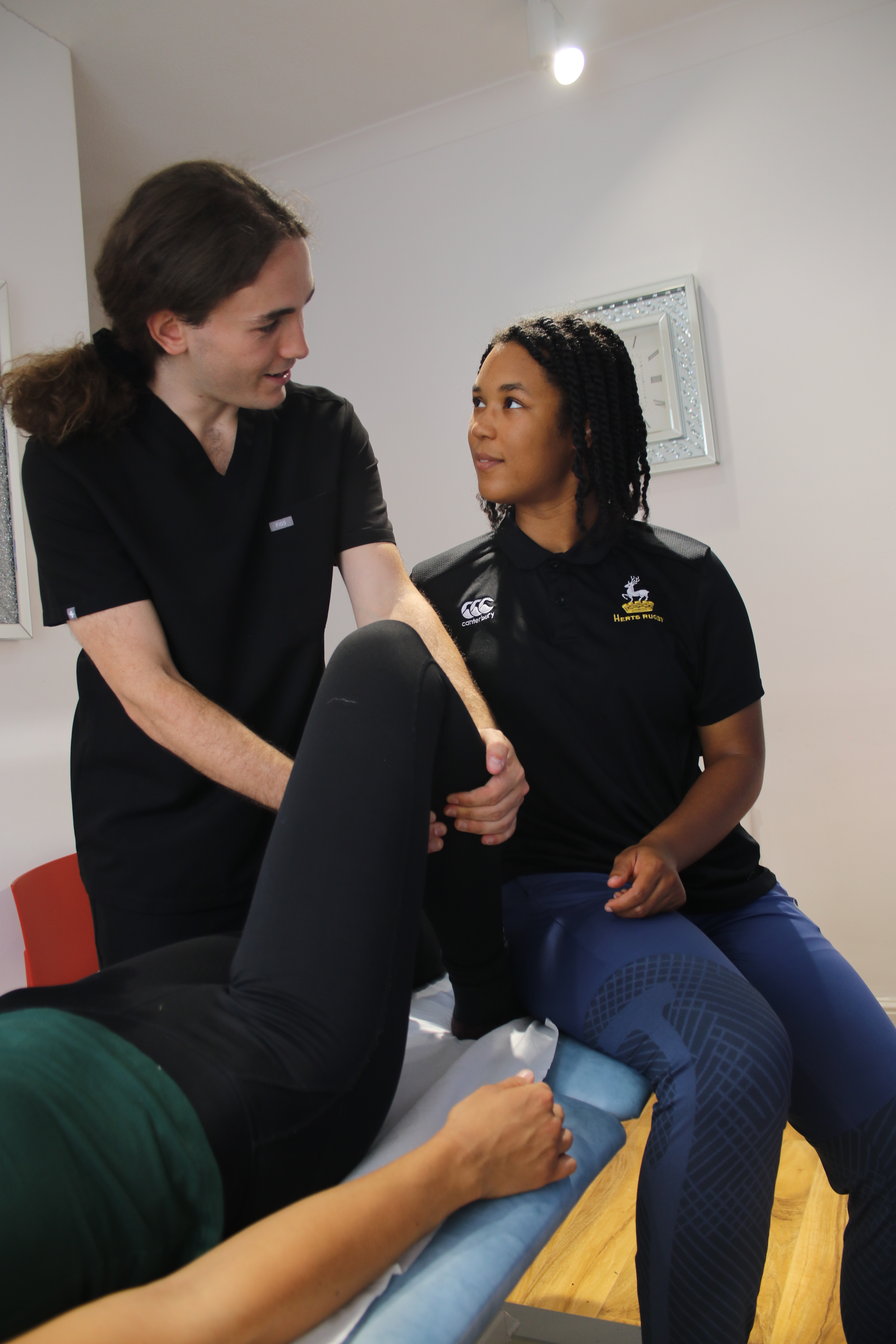 Barry osteopath teaching two women how to give massages